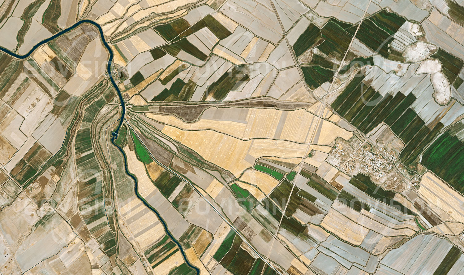 Das Satellitenbild 'HOSSEIN ABAD, Iran' ist dem Bildband "Human Footprint - Satellitenbilder dokumentieren menschliches Handeln" entnommen. Die Trockenlegung des Kamjan Sumpflandes in den 1970er Jahren ermöglichte den Ackerbau in der Ebene bei Deriyan, wo heute hauptsächlich Getreide, Reis und Baumwolle gedeihen.