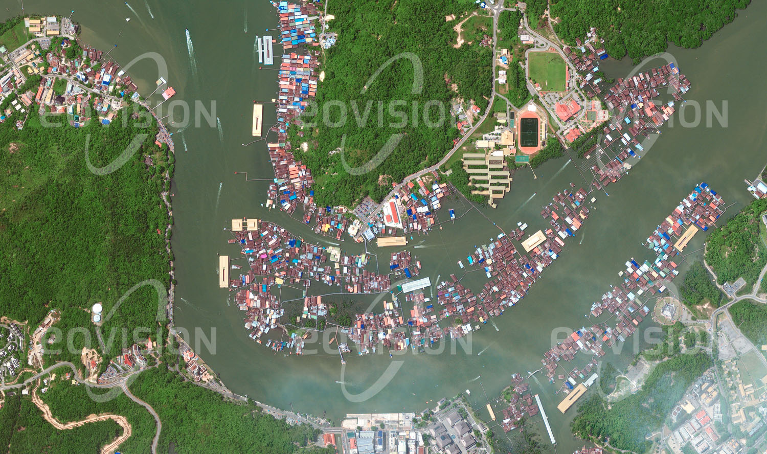 Das Satellitenbild 'KAMPUNG AYER, Brunei' ist dem Bildband "Human Footprint - Satellitenbilder dokumentieren menschliches Handeln" entnommen. Die auf Stelzen errichteten 42 Dörfer der Wasserstadt sind Teil der Hauptstadt von Brunei und beherbergen mit über 30.000 Men­schen fast ein Zehntel der Bevölkerung des Sultanats. Schon vor mehr als 1.300 Jahren bestand hier eine Pfahlbausiedlung, die später zu einem wichtigen Handelsplatz Borneos und zum Ausgangspunkt für die Entwicklung Bruneis wurde.