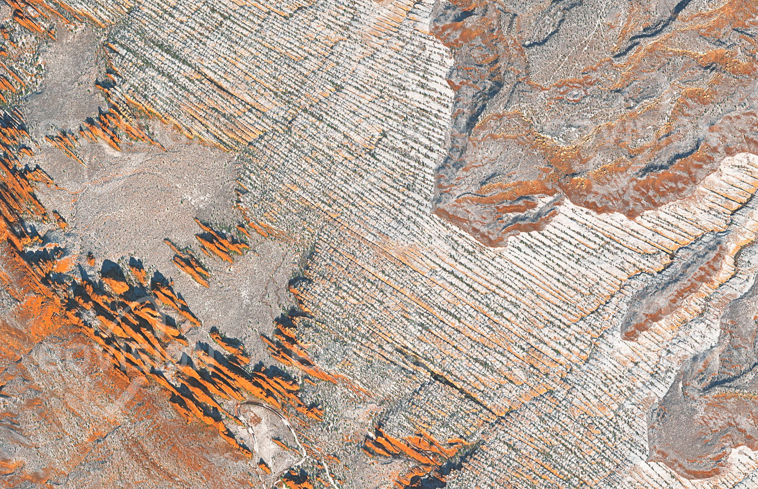 Das Satellitenbild 'MOAB, USA' ist dem Bildband "Wüsten - Lebensraum der Extreme" entnommen. Bei Moab in Utah liegt der wegen seiner zahlreichen und spektakulären Steinbögen so genannte Arches National Park. Mehr als 2000 Bögen in unterschiedlichen Größen wurden hier gezählt. Die Bögen entstanden dadurch, dass das Aufwölben eines Salzstocks zu Rissbildung in der darüber liegenden Sandsteindecke führte, wodurch lange, senkrechte Platten entstanden. Diese wurden durch Erosion schmaler, wobei die Verdünnung zum Teil Löcher in den Platten entstehen ließ. Einige der Bögen, etwa der Landscape Arch mit 92 Metern Spannweite, zählen zu den größten Felsbögen der Erde.